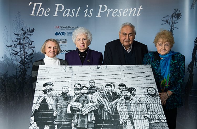 81-year-old Paula Lebovics, 79-year-old Miriam Ziegler, 85-year-old Gabor Hirsch and 80-year-old Eva Kor pose with the original image of them as children taken at Auschwitz at the time of its liberation on January 26, 2015 in Krakow, Poland. This week marks the 70th anniversary of the liberation of Auschwitz and to mark the event USC Shoah Foundation have brought together, for the first time, four of the survivors from the iconic image by Alexander Vorontsov of Auschwitz children. Auschwitz was among the most notorious of the extermination camps run by the Nazis to enslave and kill millions of Jews, political opponents, prisoners of war, homosexuals and Roma.  (Ian Gavan/Getty Images)